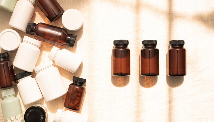A crowded shelf of supplement bottles beside three chosen bottles, showing why taking more vitamins does not make you healthier